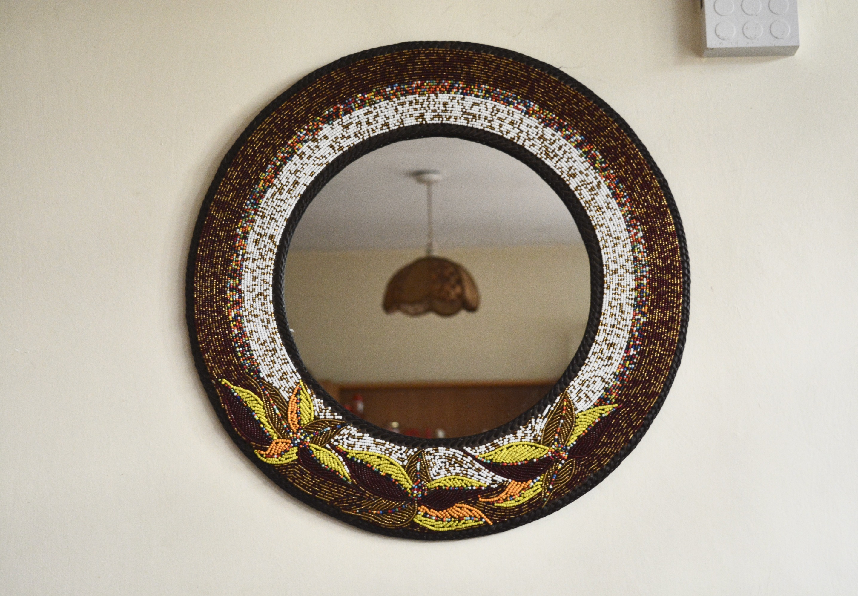 Mixed colored beaded mirror with flower